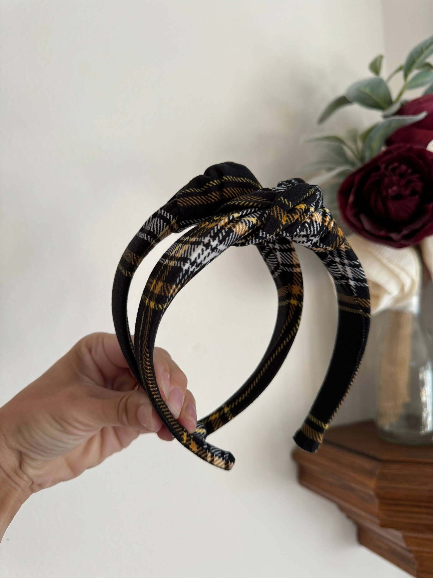 Blair Black Plaid Top Knot Headband, Add a touch of cozy charm to any outfit with the Blair Black Plaid Top Knot Headband. Its classic black plaid pattern pairs perfectly with casual looks, while the playful top knot adds a flirty finish. Soft and stretch