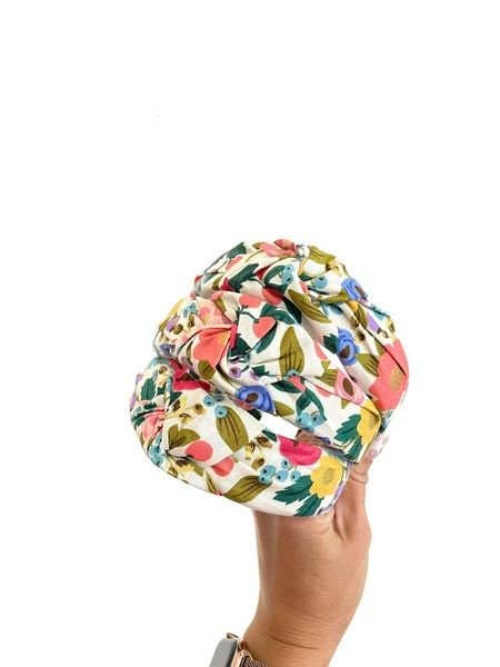 Vintage Blossom Top Knot Headband, Add a touch of retro charm to any outfit with the Vintage Blossom Top Knot Headband. Featuring a playful floral pattern, this headband effortlessly dresses up your look while keeping hair neatly in place. Perfect for add