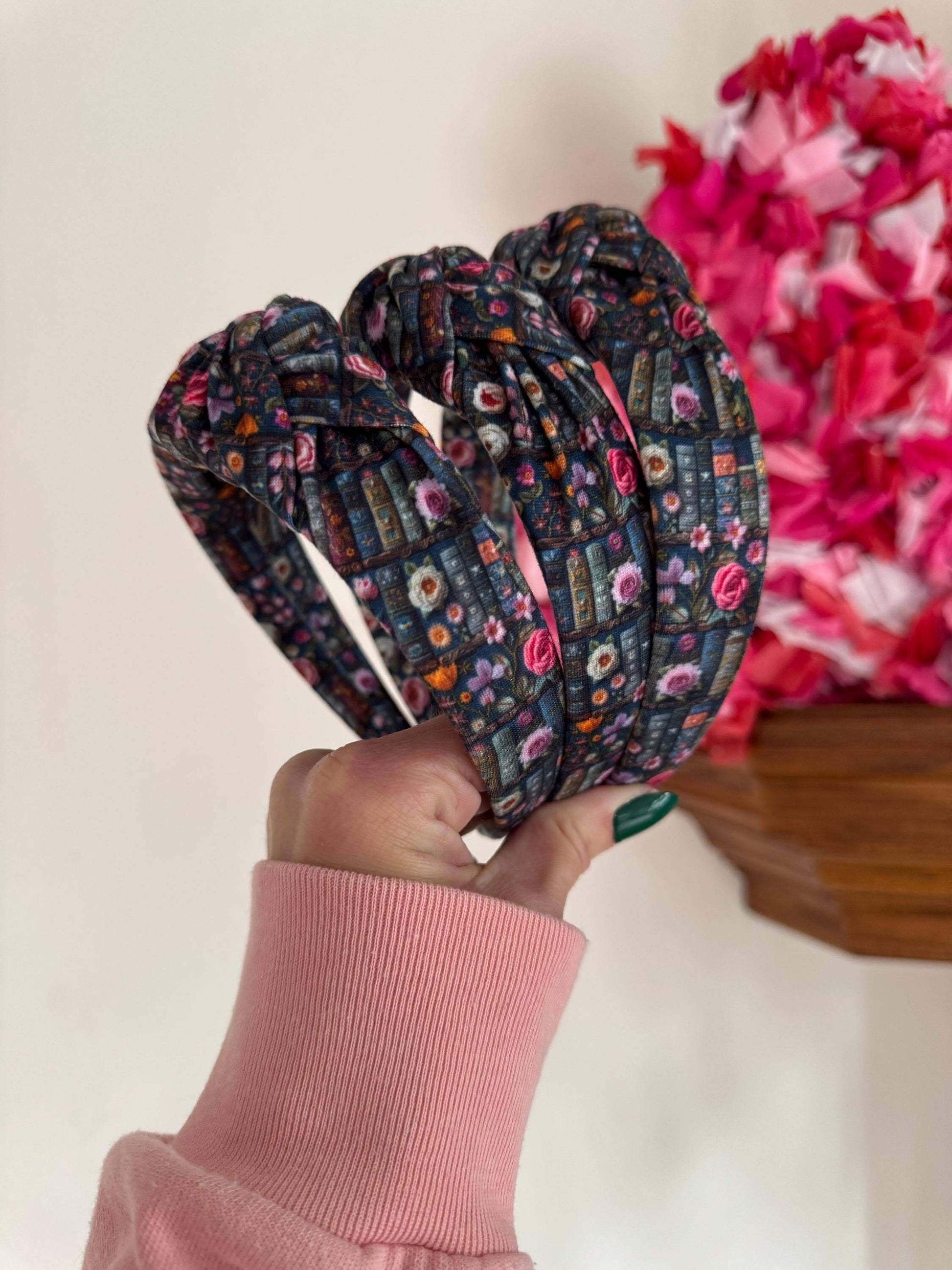 Enchanted Books Top Knot Headband, Step into a storybook world with our Enchanted Books Top Knot Headband. Featuring a darker floral print inspired by classic library tales, this low top knot headband adds a whimsical, Beauty and the Beast–inspired charm