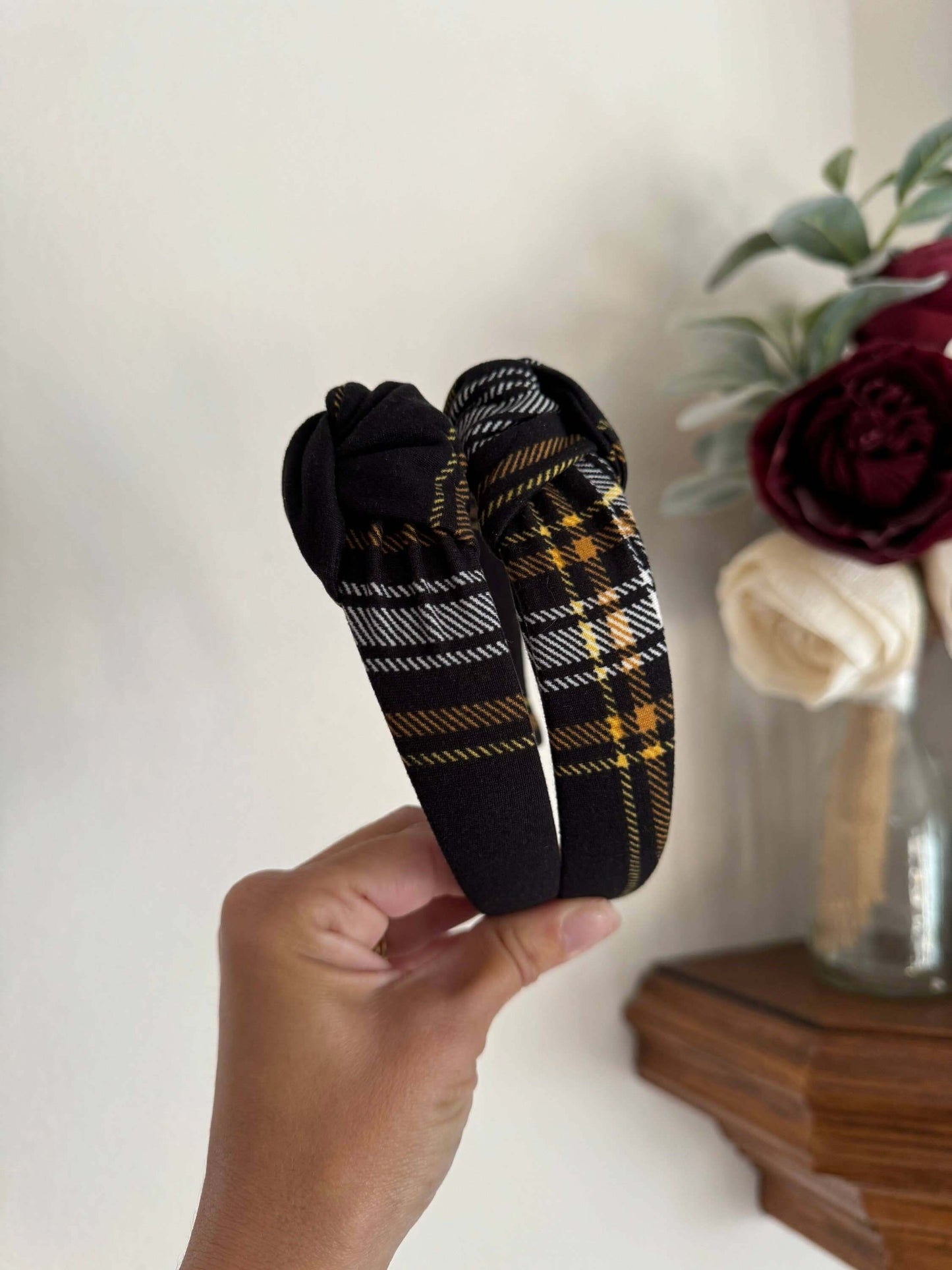 Blair Black Plaid Top Knot Headband, Add a touch of cozy charm to any outfit with the Blair Black Plaid Top Knot Headband. Its classic black plaid pattern pairs perfectly with casual looks, while the playful top knot adds a flirty finish. Soft and stretch