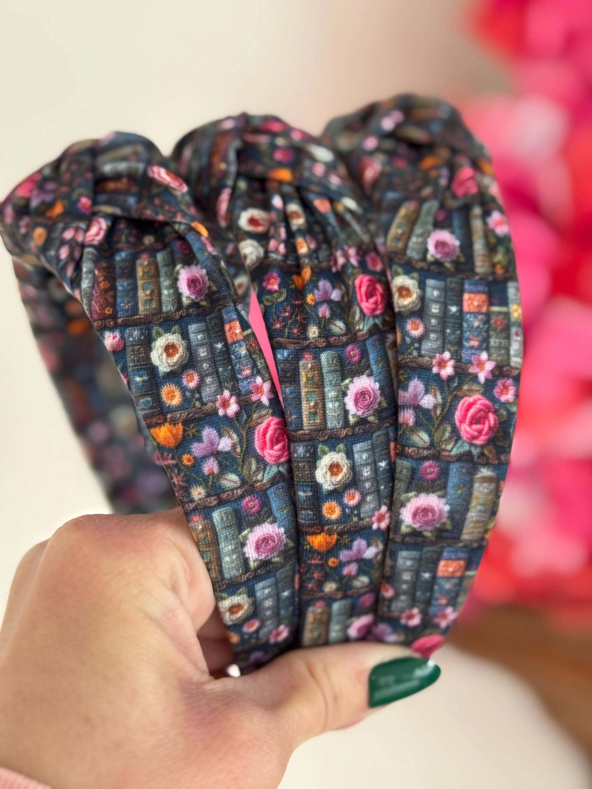 Enchanted Books Top Knot Headband, Step into a storybook world with our Enchanted Books Top Knot Headband. Featuring a darker floral print inspired by classic library tales, this low top knot headband adds a whimsical, Beauty and the Beast–inspired charm