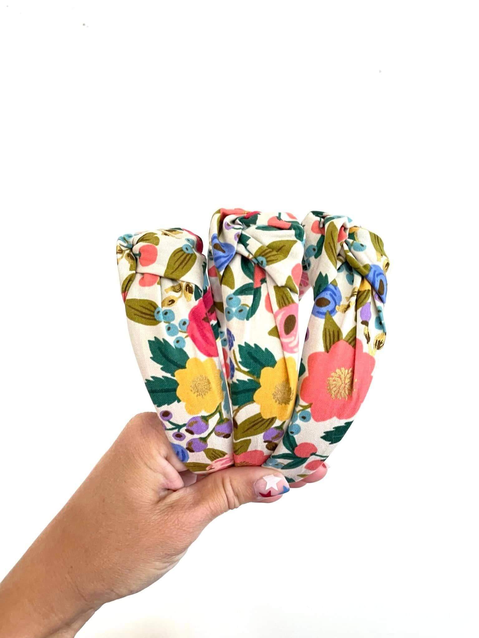 Vintage Blossom Top Knot Headband, Add a touch of retro charm to any outfit with the Vintage Blossom Top Knot Headband. Featuring a playful floral pattern, this headband effortlessly dresses up your look while keeping hair neatly in place. Perfect for add