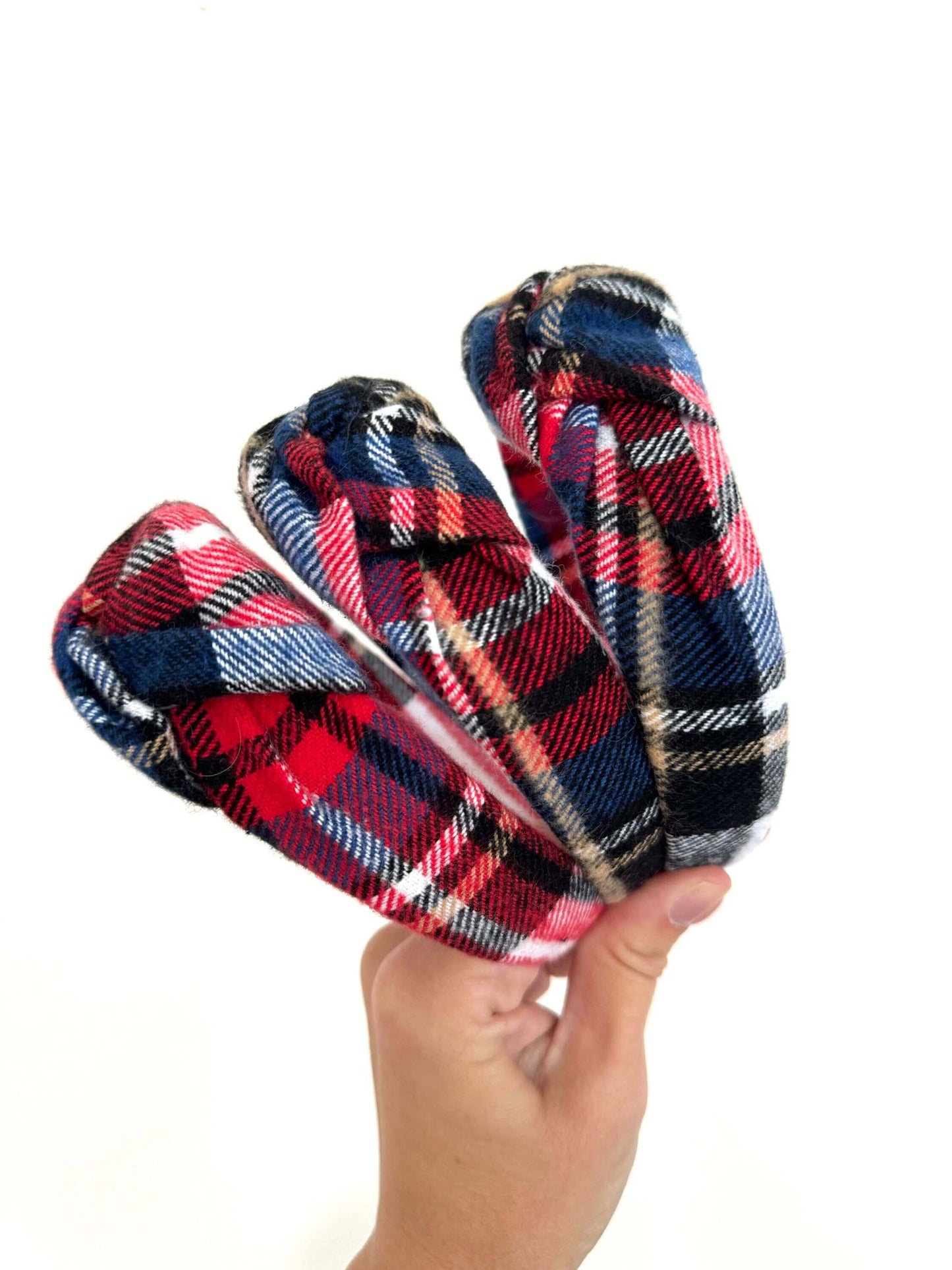 Holiday Plaid Flannel Top Knot Headband, Add a festive touch to your holiday look with this cozy plaid flannel headband. The soft fabric keeps you comfy, while the playful top knot adds a fun twist to any outfit. Perfect for chilly days or holiday parties