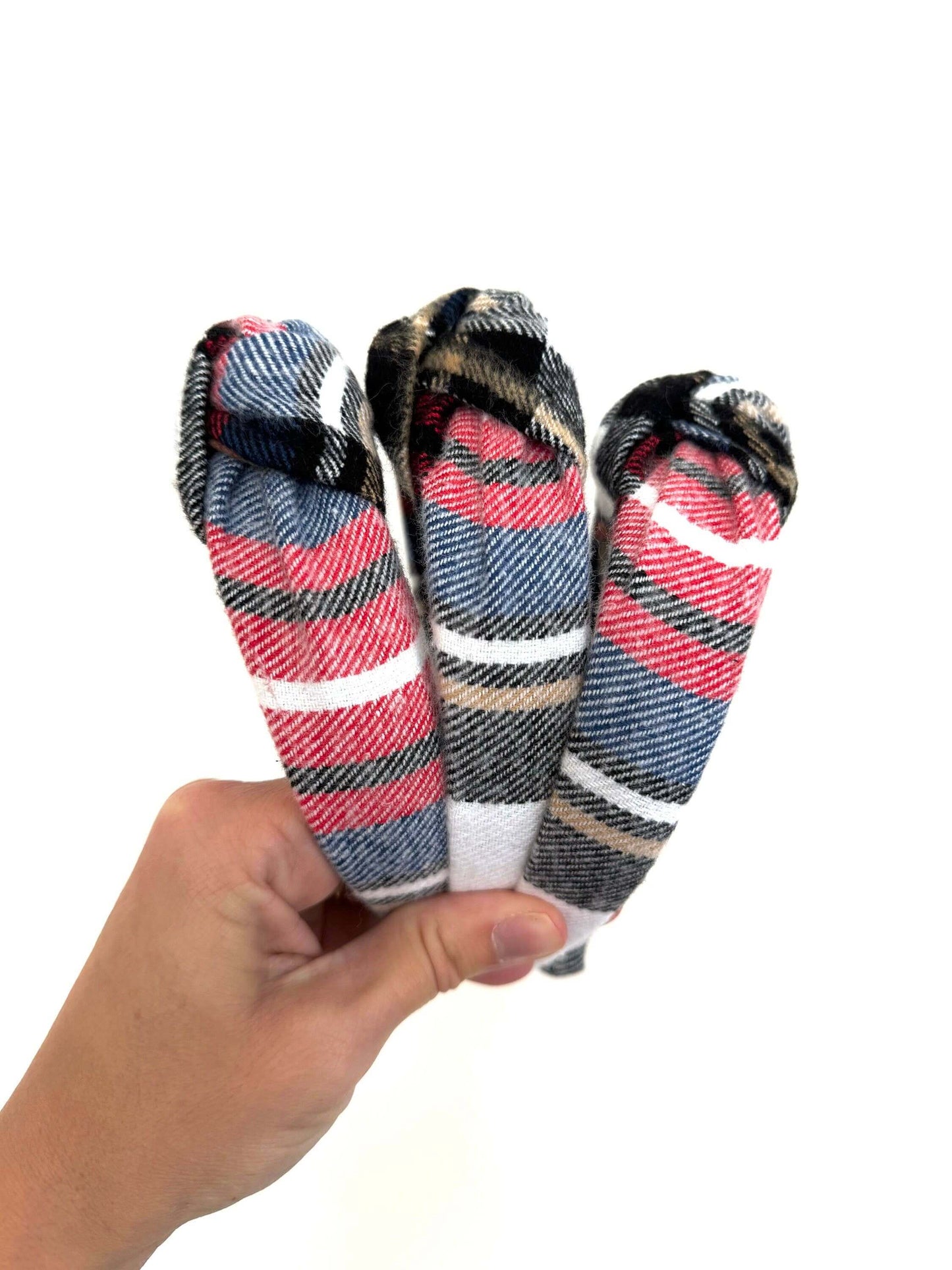 Holiday Plaid Top Knot Headband, Add a festive touch with this subtle holiday plaid top knot headband. Its classic plaid pattern brings cozy charm while the playful top knot adds a fun twist to any outfit. Perfect for holiday gatherings or everyday cheer,