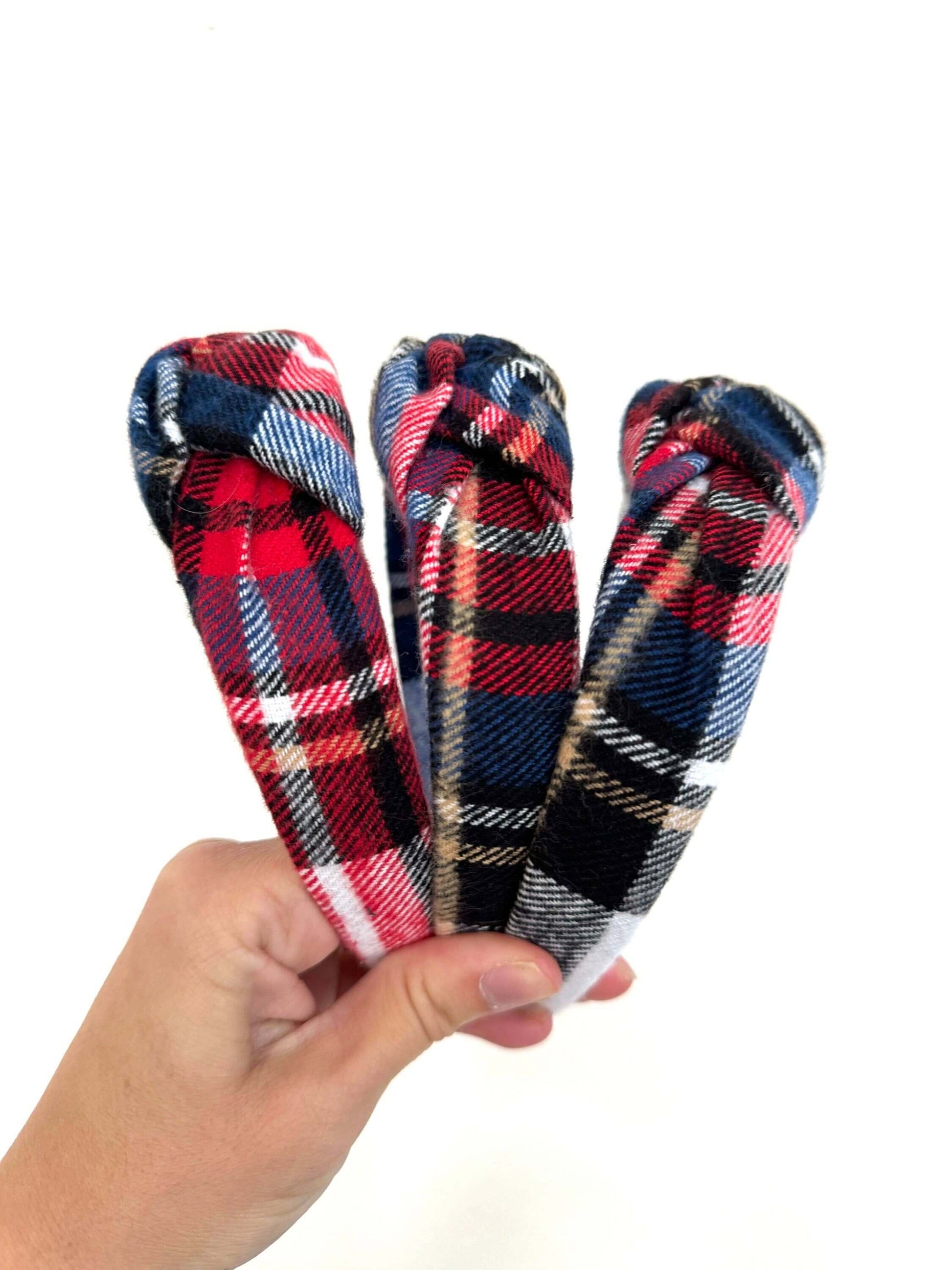 Holiday Plaid Flannel Top Knot Headband, Add a festive touch to your holiday look with this cozy plaid flannel headband. The soft fabric keeps you comfy, while the playful top knot adds a fun twist to any outfit. Perfect for chilly days or holiday parties