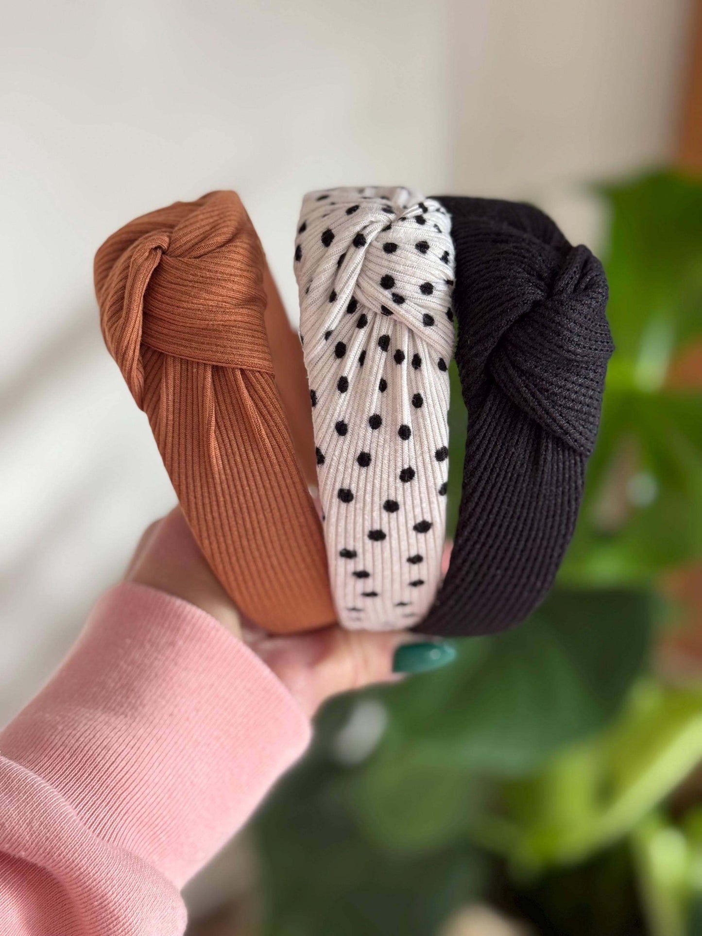 Polka Dotted Knotted Neutral Headband, Add a fun twist to your look with this white ribbed headband adorned with classic black polka dots. Its topknot design brings a playful vibe while keeping your style effortlessly neutral and versatile. Perfect for an