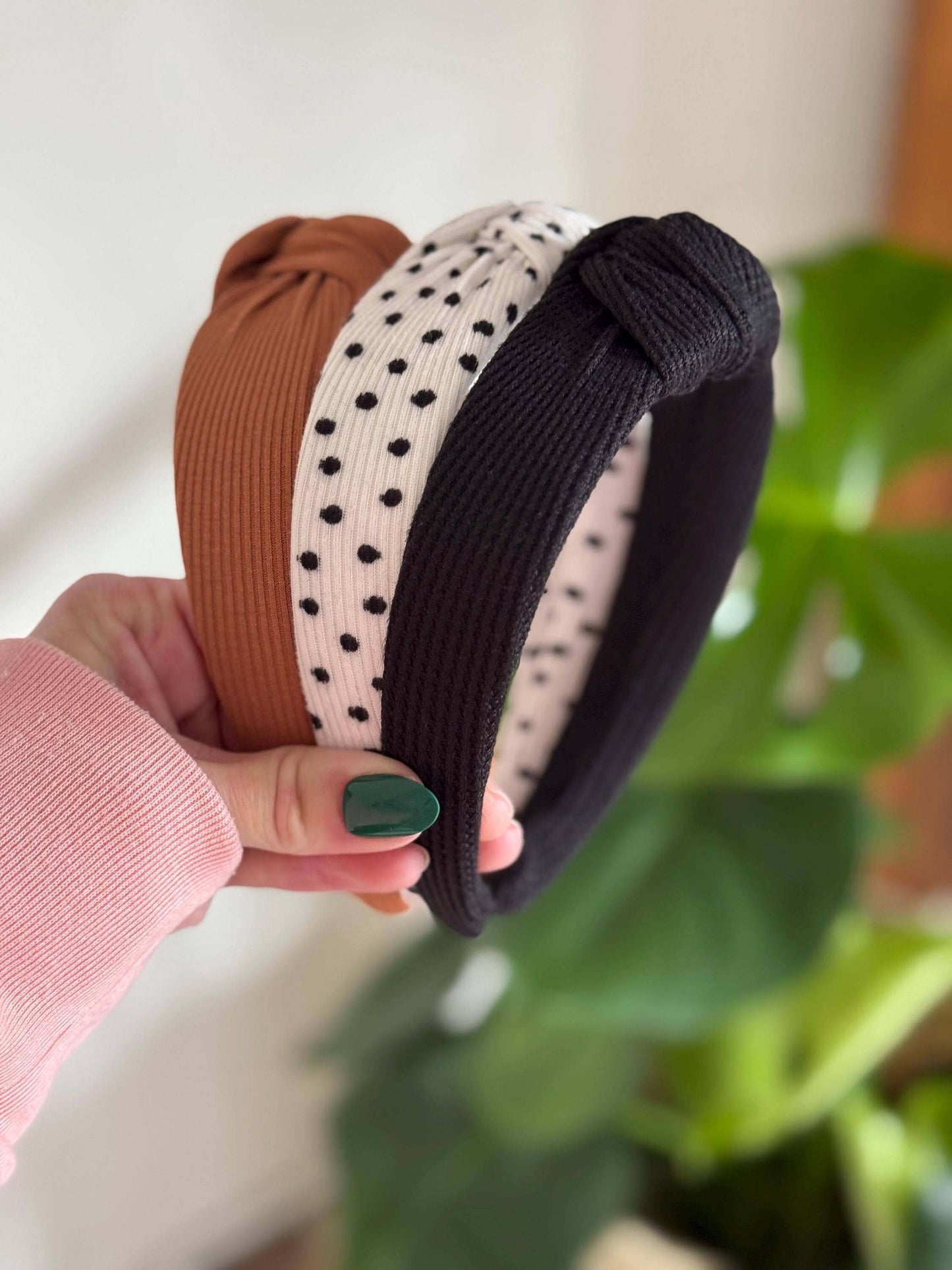 Polka Dotted Knotted Neutral Headband, Add a fun twist to your look with this white ribbed headband adorned with classic black polka dots. Its topknot design brings a playful vibe while keeping your style effortlessly neutral and versatile. Perfect for an