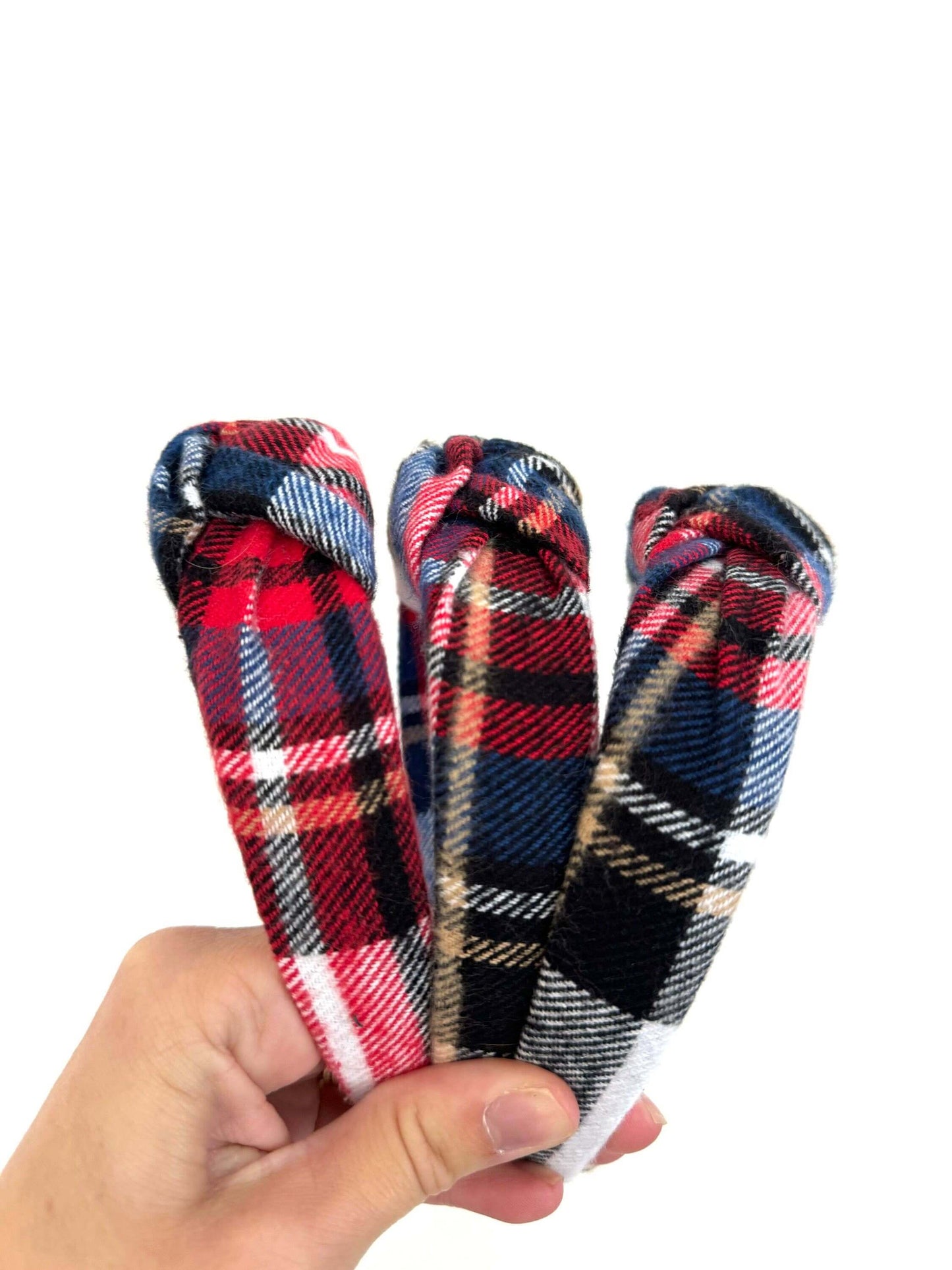 Holiday Plaid Flannel Top Knot Headband, Add a festive touch to your holiday look with this cozy plaid flannel headband. The soft fabric keeps you comfy, while the playful top knot adds a fun twist to any outfit. Perfect for chilly days or holiday parties