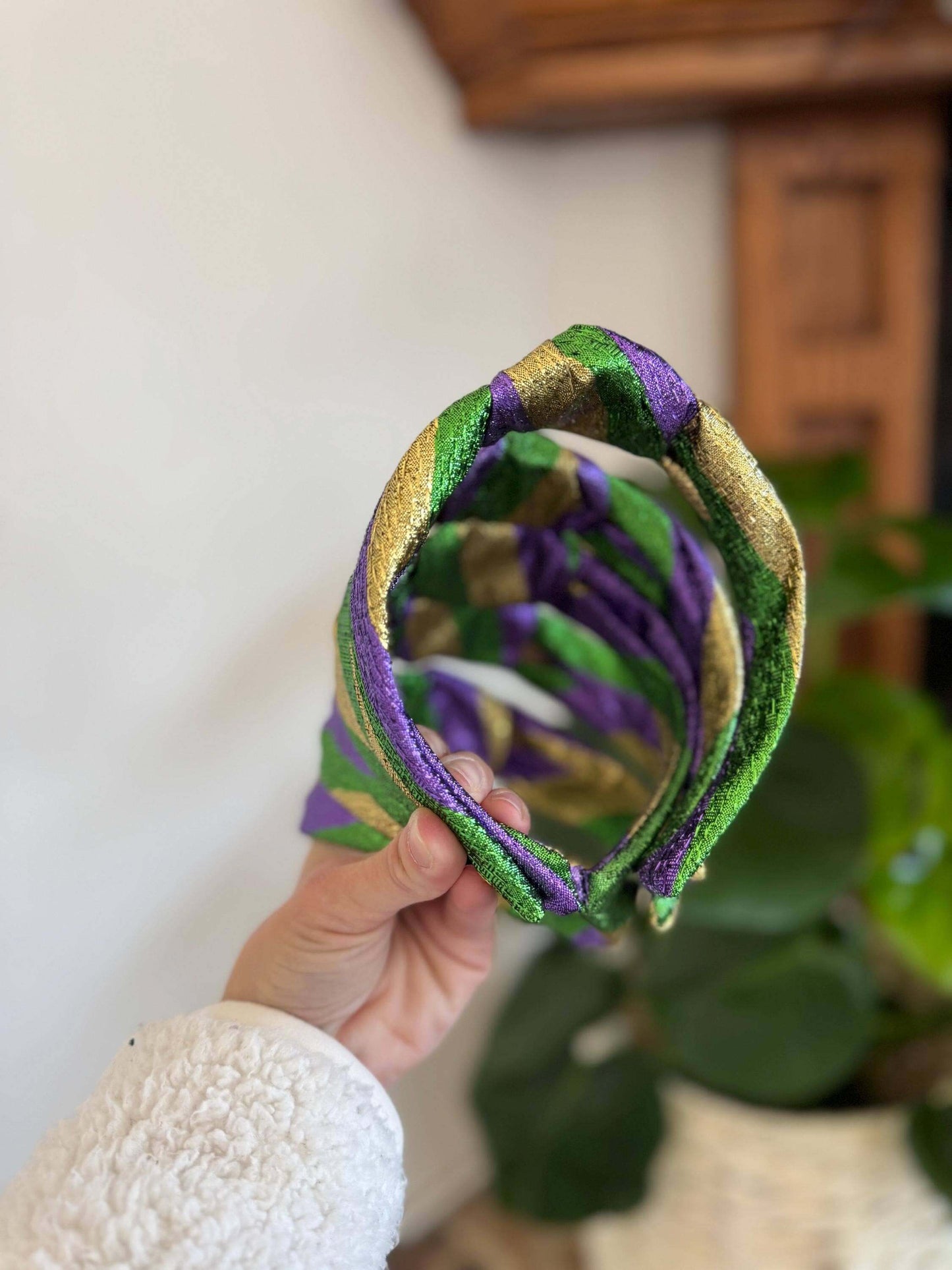 The Mardi Gras New Orleans Headband, Celebrate in style with The Mardi Gras New Orleans Headband, featuring vibrant metallic tricolor accents perfect for any festival or party. This playful top knot design adds a fun, festive touch to your outfit, making