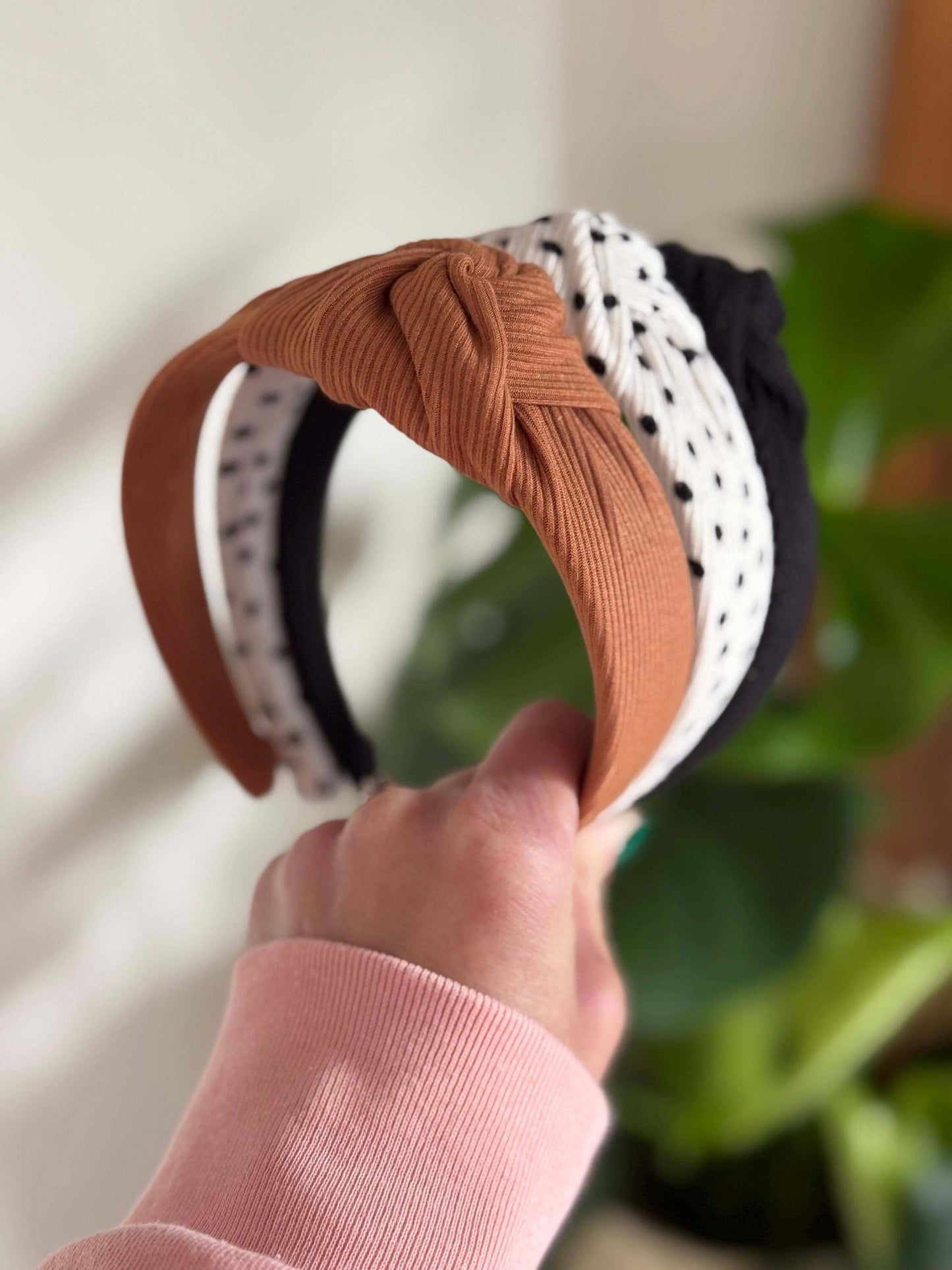 Polka Dotted Knotted Neutral Headband, Add a fun twist to your look with this white ribbed headband adorned with classic black polka dots. Its topknot design brings a playful vibe while keeping your style effortlessly neutral and versatile. Perfect for an
