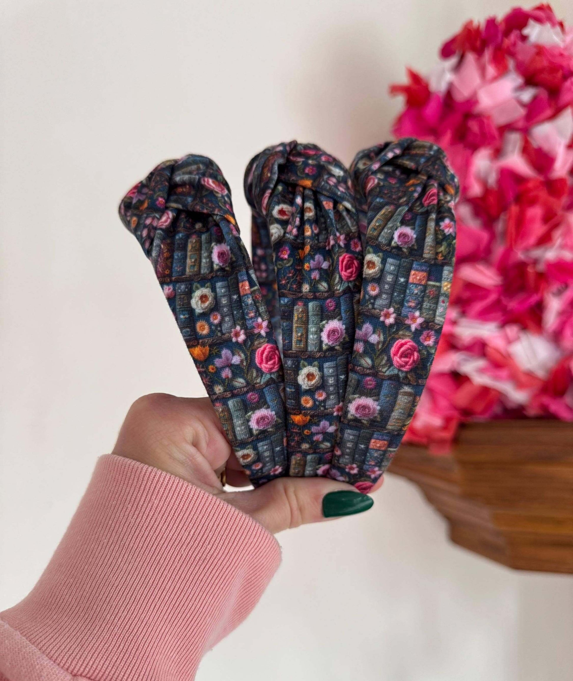 Enchanted Books Top Knot Headband, Step into a storybook world with our Enchanted Books Top Knot Headband. Featuring a darker floral print inspired by classic library tales, this low top knot headband adds a whimsical, Beauty and the Beast–inspired charm